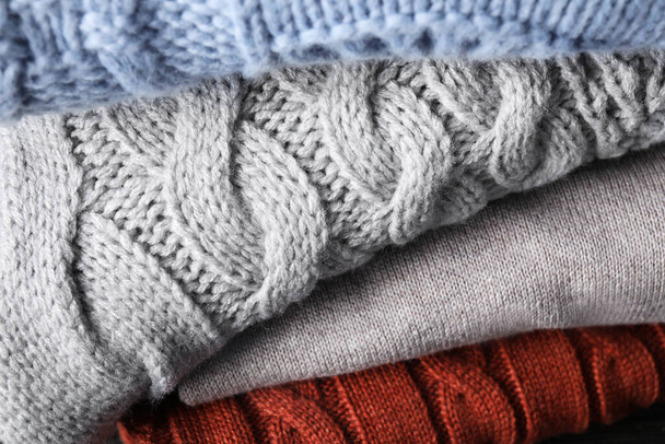 Stack of folded warm sweaters, closeup view - Foto, Imagem