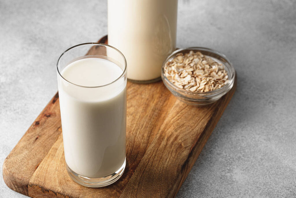 Vegan oat milk with oat flakes close up - Fotografie, Obrázek