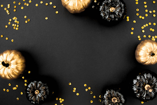 Modern background with black and gold Halloween pumpkin with copy space for text. isolated on black background. Flat lay, top view. - Photo, image