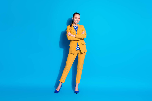 Full length photo of pretty confident charming elegant girl in bright suit holding arms folded isolated blue color background - Фото, зображення