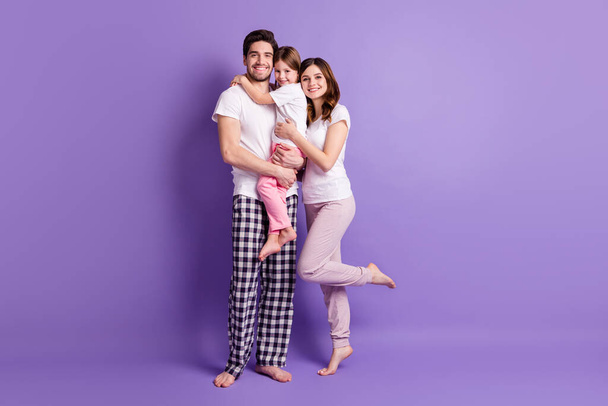 Full length body size view of cheerful careful affectionate family three person embracing wearing pajama harmony isolated on bright vivid shine vibrant violet color background - Photo, Image