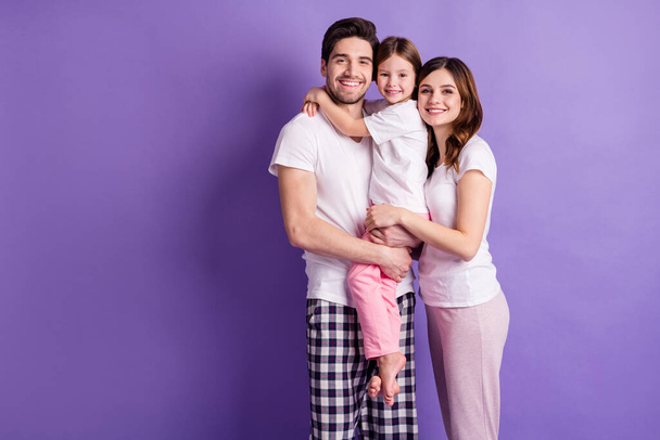 Portrait of three person cheerful careful loving family mom dad offspring daughter wearing cozy pajama harmony idyllic isolated on bright vivid shine vibrant violet color background - Valokuva, kuva