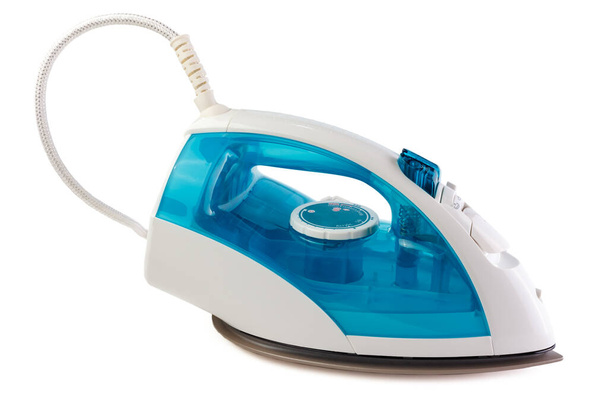 The electric iron stands on isolated white background. There is some free space for your text or sign. - Photo, image