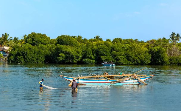 A view of fishermen landing their catch in the lagoon in Negombo, Sri Lanka - Zdjęcie, obraz