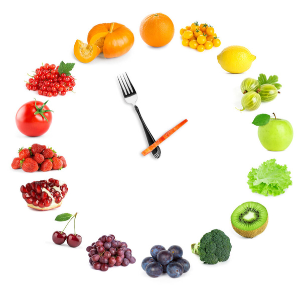 Food clock with fresh fruits and vegetables. Healthy food - 写真・画像