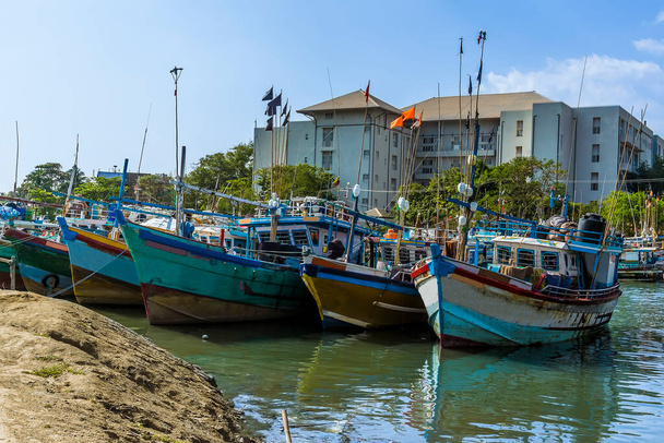 A view of fishing vessel moored along the entrance to the lagoon in Negombo, Sri Lanka - Foto, imagen
