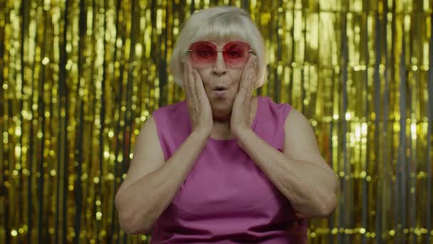 Porträt einer aufgeregten, verwunderten Seniorin, die in die Kamera blickt und erstaunt den Mund öffnet - Filmmaterial, Video