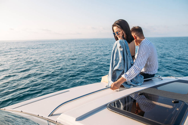 Caucasian couple in love relaxing on yacht bow, Travelling lifestyle concept - Foto, afbeelding
