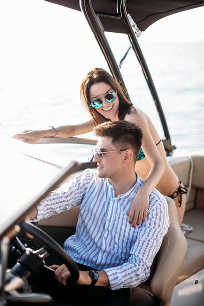 Young married couple having sea excursion on motor boat - Foto, immagini