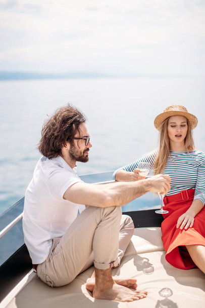 Young beautiful married couple embracing on the yacht on vacation - Фото, зображення