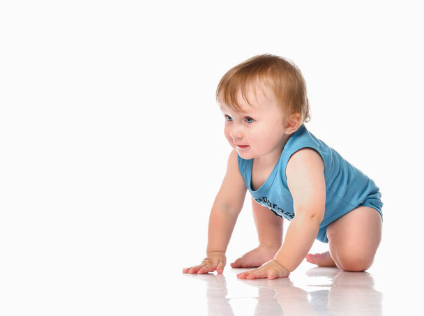 Infant child baby boy crawling and happy looking, isolated on a white background. - Photo, Image