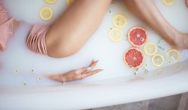beautiful sexy woman in the milk bath with flowers - 写真・画像
