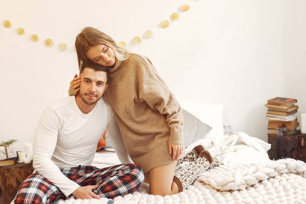 Couple sitting on a bed in a room - Photo, image