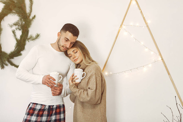 Couple spend time at home with christmas decorations - Photo, image
