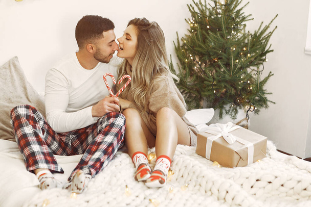 Couple spend time at home with christmas decorations - Фото, изображение