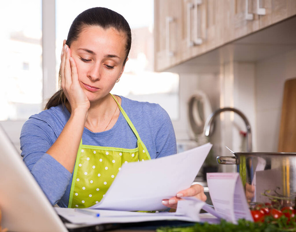 Upset and tired woman filling papers - Foto, imagen