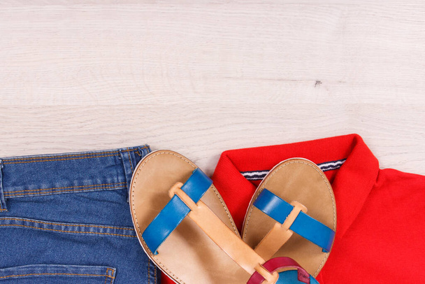 Fashionable and comfortable leather sandals, blue jeans and cotton shirt for woman, place for inscription - Foto, afbeelding
