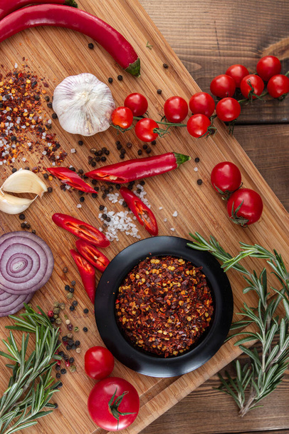 spices onion red pepper garlic on wood board - Фото, изображение