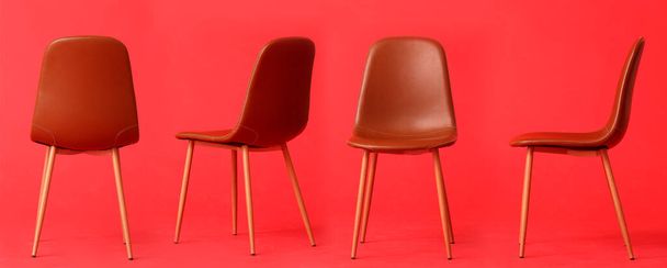 Set of trendy chairs on red background - Photo, Image