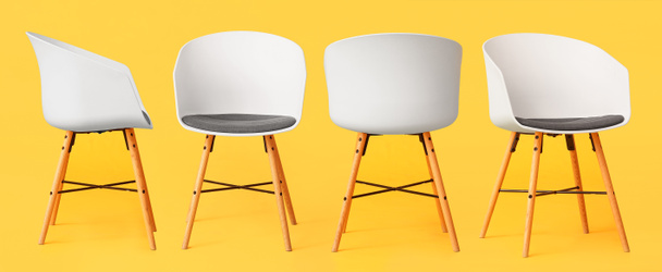 Set of trendy chairs on yellow background - Photo, Image
