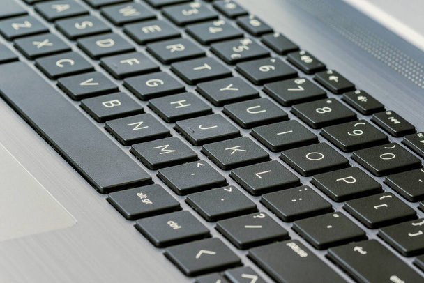 Close up view of computer keyboard with aluminium body. Selective focus. - Fotó, kép