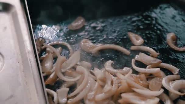 Frying onion in slow motion for burgers - Footage, Video