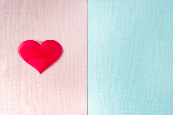 The textured pink and blue background is divided into equal parts. The pink part has a red heart. Copy space - Fotografie, Obrázek