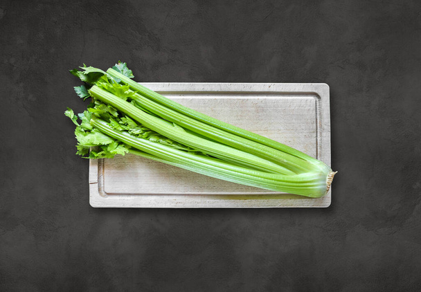 Celery branch bunch on a wooden cutting board - Photo, Image