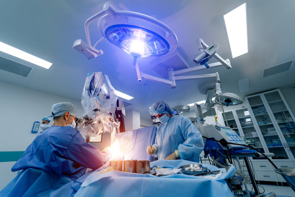 Neurosurgeon operation in hospital. Health care concept. Surgeons team working. Selective focus. Medical room background. Modern equipment. - Foto, imagen