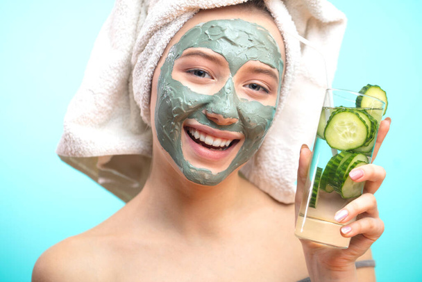 European woman relaxing during beauty treatment, drinking organic cocktail - 写真・画像