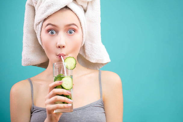 Funny cute attractive surprised white girl drinking green cocktail using a straw - 写真・画像
