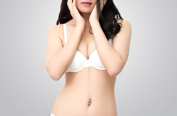 close up image of portrait woman in white bra and gray background - Photo, Image