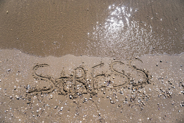 Schild STRESS am Strand mit türkisfarbenem Wasser - Foto, Bild