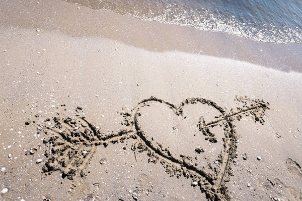 hearts drawn on the sand of a beach - Photo, Image