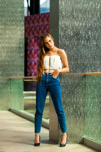 Full body portrait of a young beautiful brunette model in blue jeans - Photo, Image
