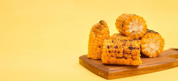 grilled corn on a yellow background, copy space - Фото, изображение