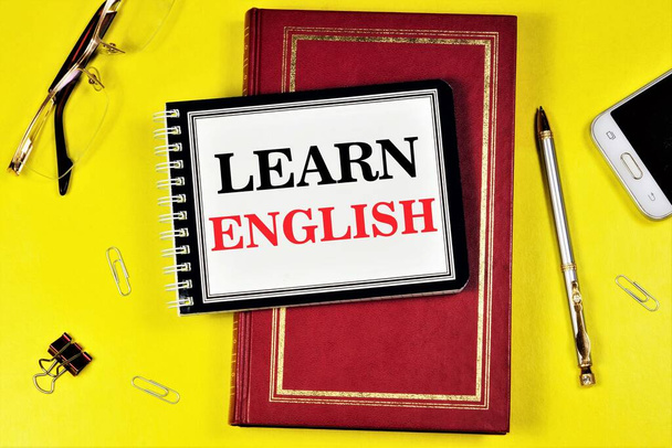 Learn English.- writing text in a notebook on a textbook. Learning spelling grammar and conversational practice. - Photo, Image