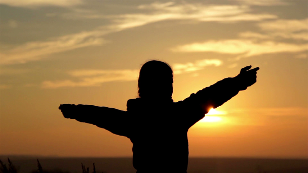 Nainen auringonnousun aikaan, tyttö siluetti aamunkoitteessa
 - Materiaali, video