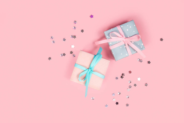Cute small gift boxes on pink background. Top view. Copy space. - Φωτογραφία, εικόνα