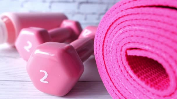  pink color dumbbell, exercise mat and water bottle on white background  - Footage, Video