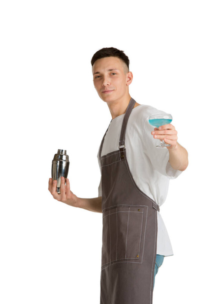Isolated portrait of a young male caucasian barista or bartender in brown apron smiling - Foto, imagen