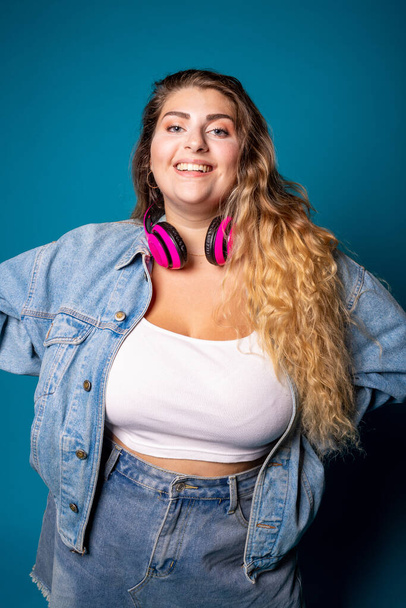 Young beautiful chubby woman smiling isolated - Confident plus size woman having fun on blue background - body positivity, self esteem, confident concept - Photo, Image