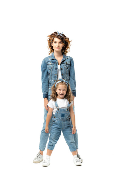 mother and daughter in denim outfits posing isolated on white - Foto, immagini