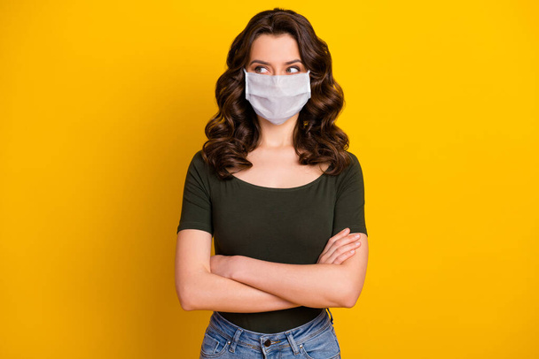 Portrait of her she nice attractive content healthy wavy-haired girl folded arms wearing safety mask stop viral pneumonia pandemia isolated bright vivid shine vibrant yellow color background - Foto, afbeelding