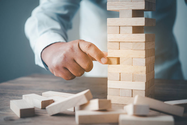 Business risks in the business. Requires planning Meditation must be careful in deciding to reduce the risk in the business. As the game drew to a wooden block from the tower - Photo, Image
