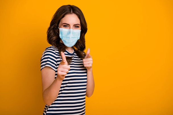 Portrait of her she attractive content wavy-haired girl wearing safety gauze mask pointing you influenza preventive measures stop pandemia isolated bright vivid shine vibrant yellow color background - Photo, image