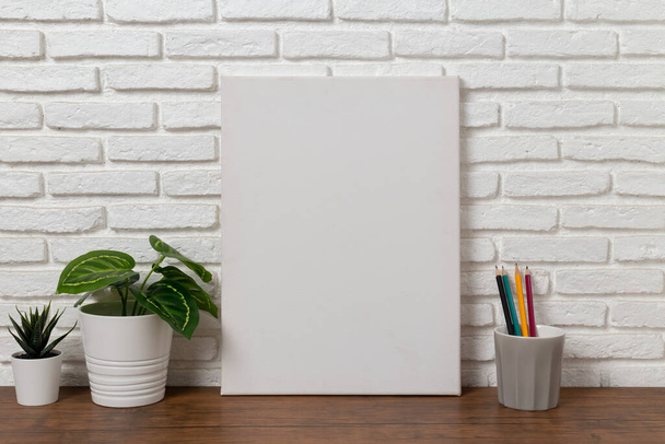 mock up canvas frame on a wooden table - Фото, зображення