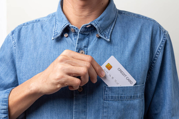 business man holding a white credit card on a white background - Zdjęcie, obraz