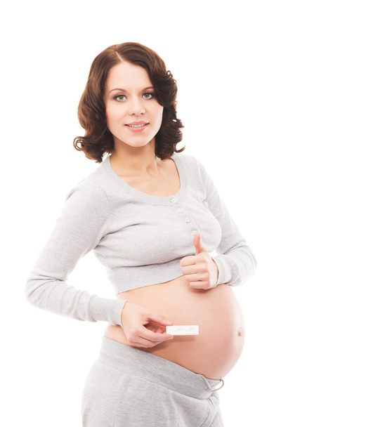 A young brunette pregnant woman isolated on a white background - Фото, изображение