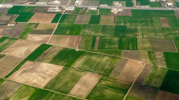 Aerial view of fields with traditional Greek agriculture seen from an airplane window. - Photo, Image